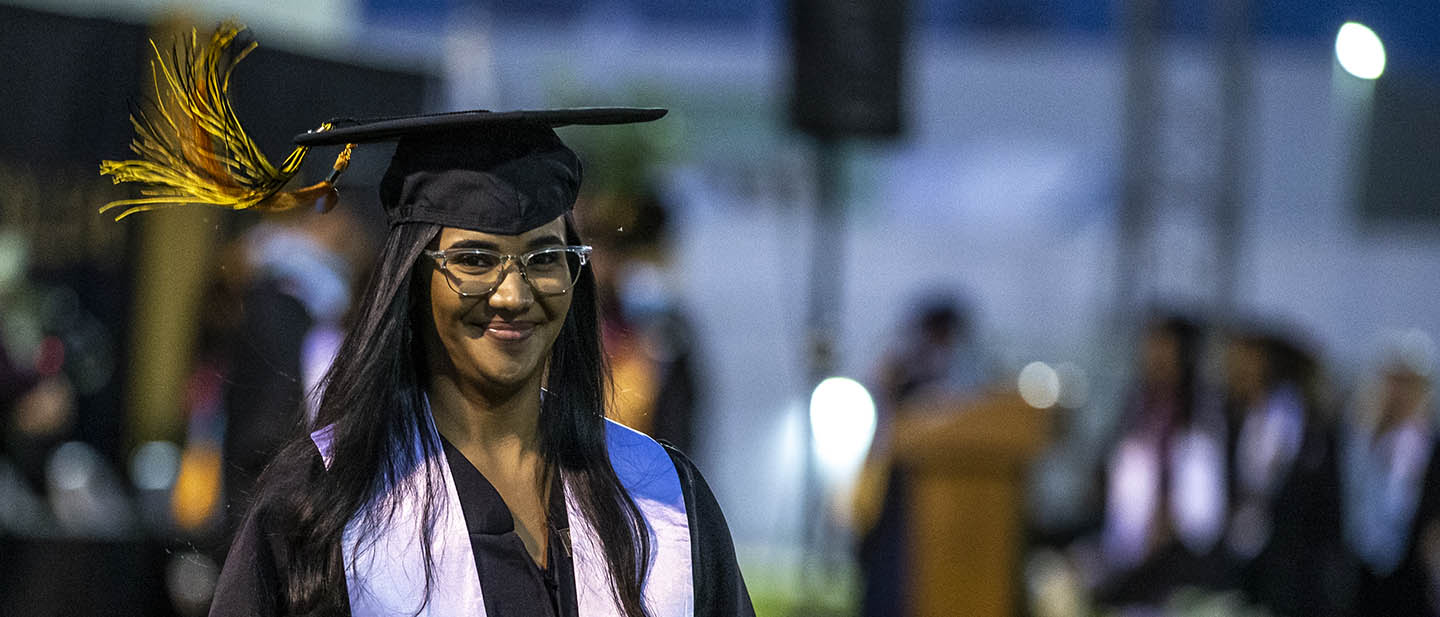 A happy Taft College Class of 2022 graduate proudly displays her just-received diploma cover.