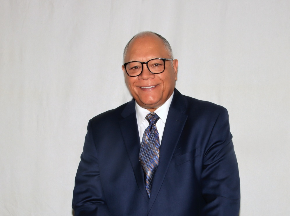 Jim Anderson wearing a blue suit with a red tie