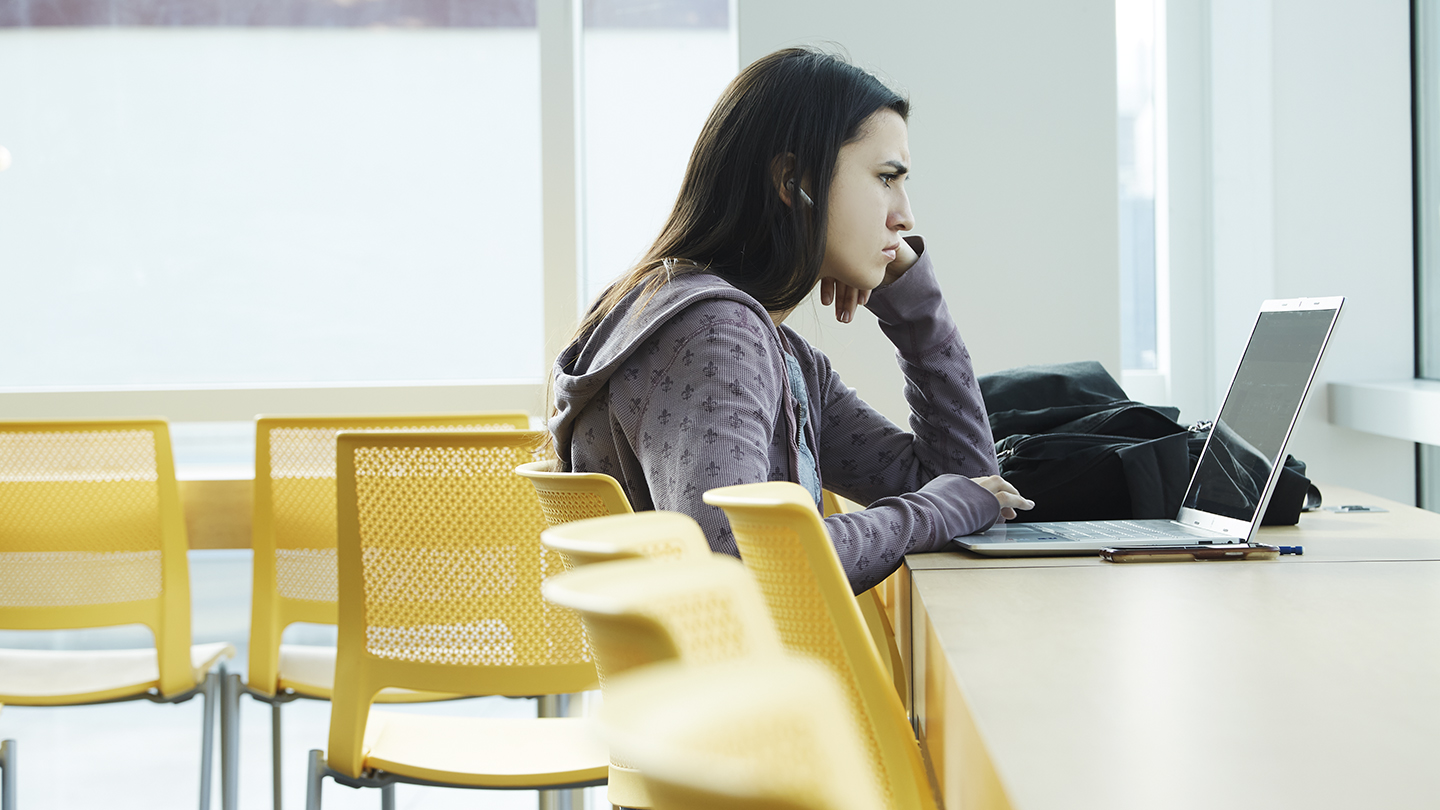 A student alone in the Student Center lounge.