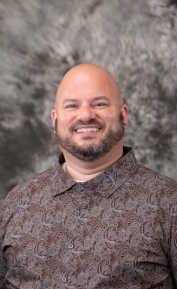 Head shot of John Bench in button down shirt.