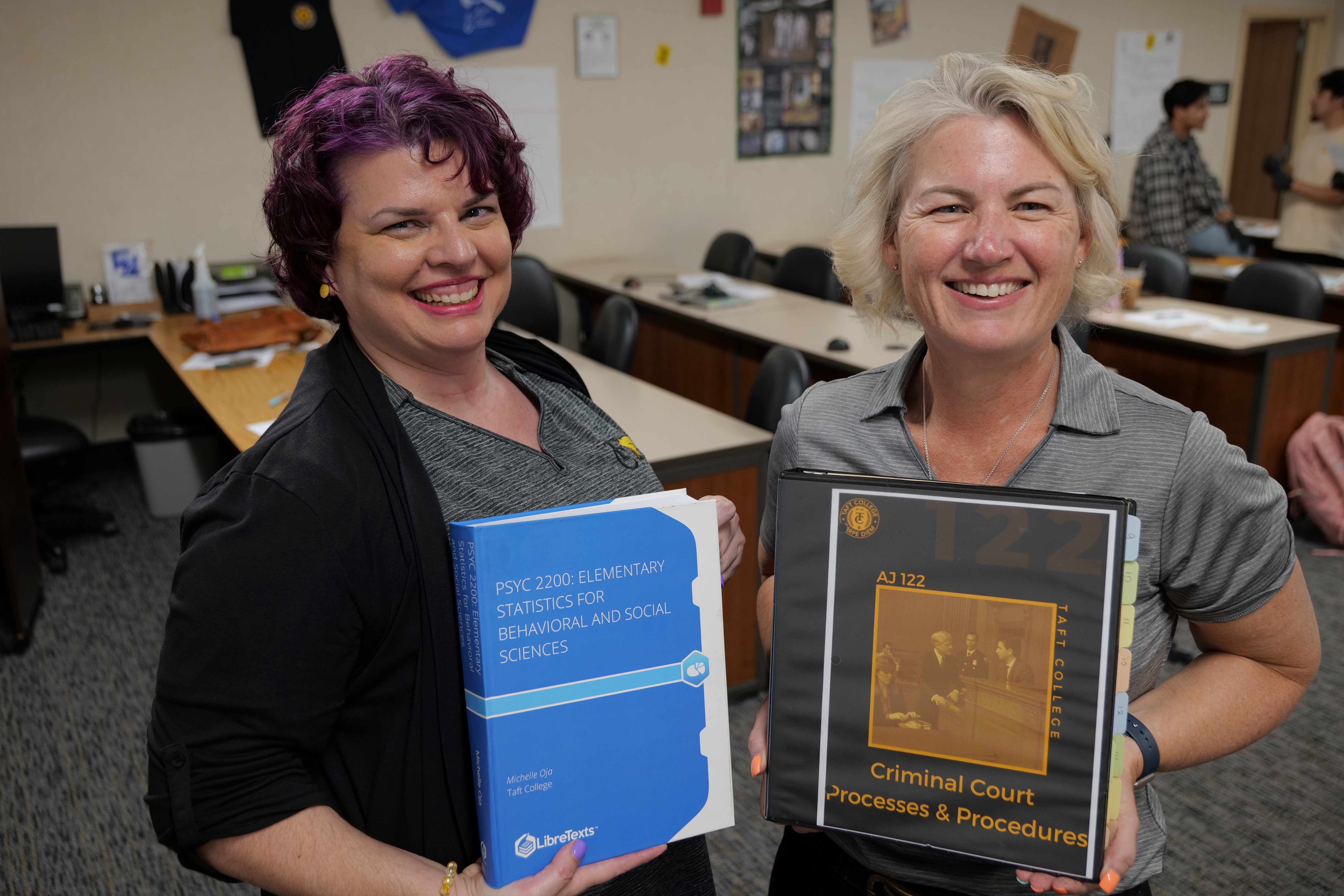 Prof.s Oja and Raber holding their OER textbooks
